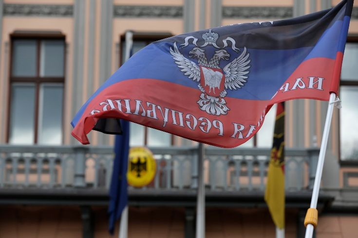 A protester waves a self-declared Donetsk People's Republic flag in front of Germany's embassy in Riga