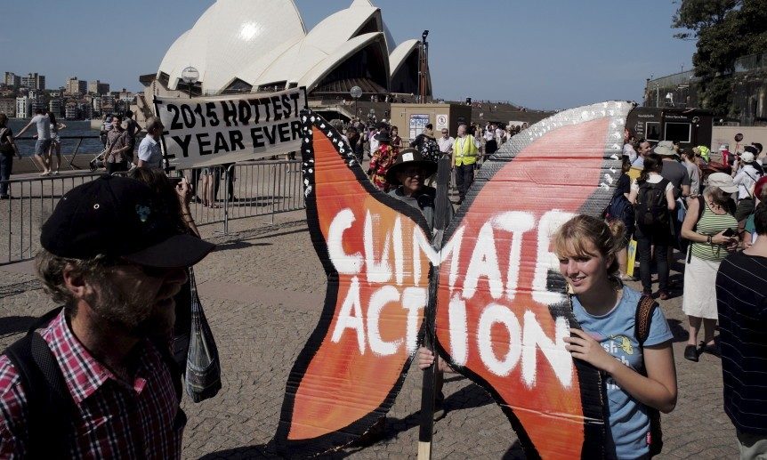 Protester Amy Walburn holds a butterfly-shaped placard in front of the Sydney Opera House during a rally held ahead of the 2015 Paris Climate Change Conference, known as the COP21 summit, in Sydney's central business district, Australia November 29, 2015. REUTERS/Jason Reed